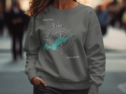 Gray sweatshirt with "Beautiful Cedar Lake Ontario" text and compass graphic.