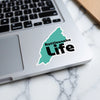 Teal outline sticker with "Rattlesnake Life" text on a laptop.