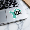 Turquoise outline sticker with black text "Union Life" on a laptop keyboard.
