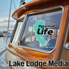 Turquoise Pyramid Life sticker on a wooden boat window, with Lake Lodge Media logo.