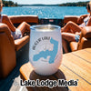 A white travel tumbler with an Augur Lake, New York map design sits on a boat table.