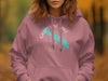 Pink hoodie with a turquoise outline of Grapevine Lake and compass design.