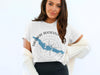 White t-shirt with blue lake graphic and compass rose, reading "Theodore Roosevelt Lake Arizona".