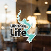 Whitney Life graphic sticker with a teal lake outline on a glass surface.