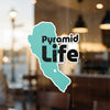 Turquoise shape with "Pyramid Life" text, displayed on a window.