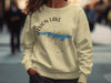 Light yellow crewneck sweatshirt with Atsion Lake New Jersey compass design and copyright text.