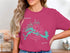 Turquoise Flagstaff Lake map graphic with compass on pink t-shirt.