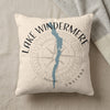 Light colored pillow with a blue Lake Windermere map and compass design.