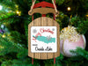 Sled ornament with "Merry Christmas From Oneida Lake" text, hanging on a Christmas tree.