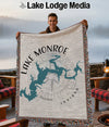 Man holding a blanket with a Lake Monroe Indiana map and compass design.
