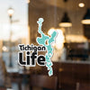"Tichigan Life" text with a teal lake outline sticker on glass 9 words