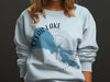 Light blue sweatshirt with Clear Lake, California map graphic and compass rose.