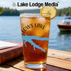 Glass of iced tea with a lemon slice and "LOWS LAKE" graphic on a wooden table.