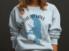Flathead Lake Montana graphic on light blue sweatshirt with compass rose.