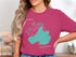 Pink t-shirt featuring a teal map outline of Lake Mendota, Wisconsin, with compass rose design.