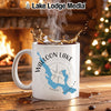 White mug with "Walloon Lake Michigan" map and compass design, steam rising.