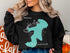 Black sweatshirt with teal outline of Canobie Lake, New Hampshire.