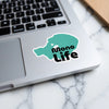 Teal sticker with "Mono Life" text on a laptop keyboard.