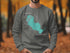 Grey sweatshirt with teal Sandhill Lake Wisconsin graphic and compass rose.
