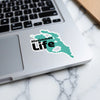 Kissimmee Life sticker with teal map outline on a laptop keyboard.