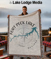 Man holding Fort Peck Lake Montana map blanket with compass design.