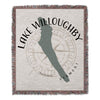 Tapestry blanket with Lake Willoughby Vermont outline and compass rose design.