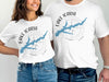 White t-shirts featuring "Lake Icaria Iowa" text and a blue lake map on a compass.