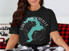 Black t-shirt with turquoise Lake Pend Oreille map and compass graphic.