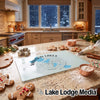 Glass cutting board featuring a Madison Lakes Wisconsin compass design, resting on a holiday kitchen counter.