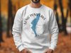 White sweatshirt with the inscription "LONG POND LAKE NEW HAMPSHIRE" and blue lake silhouette.