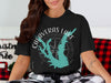 Black t-shirt featuring a teal map of Calaveras Lake, Texas with compass rose.