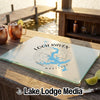 Glass cutting board with a blue Loch Raven, Maryland map and compass design on a wooden table.