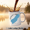 White mug with "Convict Lake" and California outline, coffee splashing.