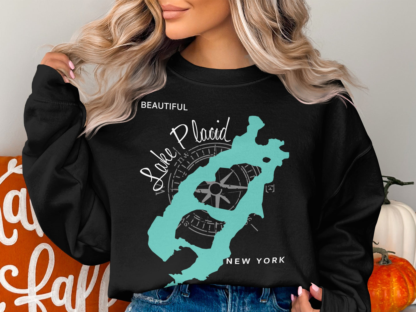 Black sweatshirt with a turquoise Lake Placid, New York map and compass graphic.