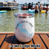 A white insulated wine tumbler with Percy Priest Lake Tennessee branding rests on a wooden boat deck.