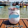 A white insulated wine tumbler with a compass graphic and Grand Lake St. Marys text rests on a boat deck.
