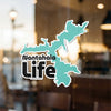 Nantahala Life sticker on a window, featuring a teal lake outline and black text.