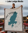 Lake Tiorati, New York map blanket held by smiling man with lake background.