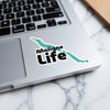 Sticker with teal wavy shape and "Maligne Life" text on laptop keyboard.