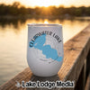A white insulated wine tumbler featuring a blue lake map and Clearwater Lake Minnesota text rests on a wooden dock with a lake sunset background.