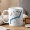 White mug with "Lake Ullswater England" and compass design, steaming gently.