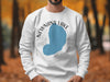 White sweatshirt with Newnans Lake, Florida map and compass graphic.