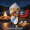 Glass with drink topped with whipped cream, beside s'mores ingredients with campfire scene.