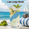 Glass of drink with limes and mint on beach with sailboat and sunglasses
