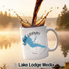 White mug with Lake Granby, Colorado map and compass design, with coffee pouring in.