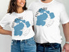 White t-shirts with blue Floyd Lake, Minnesota map and compass design.