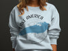 Light blue sweatshirt with Lake America graphic and compass design.