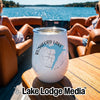 A white insulated wine tumbler with a Rushford Lake New York graphic rests on a boat table.
