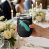 Black tumbler with teal Onondaga Lake map and compass design, held by a hand.