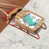 Wooden sled ornament with red runners, reads "Merry Christmas FROM Topaz Lake".